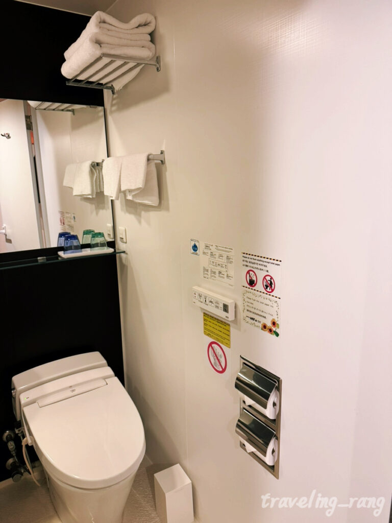 Standard Twin Room with orange interior at WBF Grande Hakata
