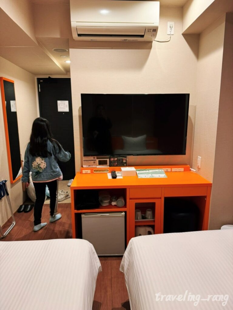 Standard Twin Room with orange interior at WBF Grande Hakata